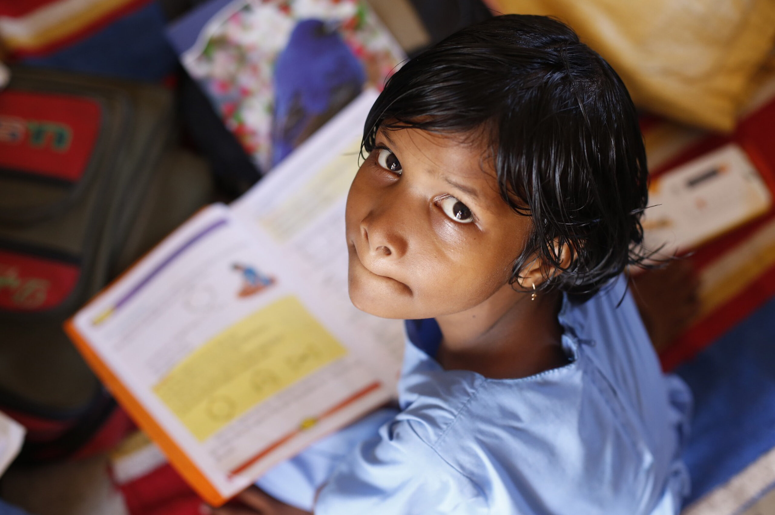 a girl looking up from schoolwork