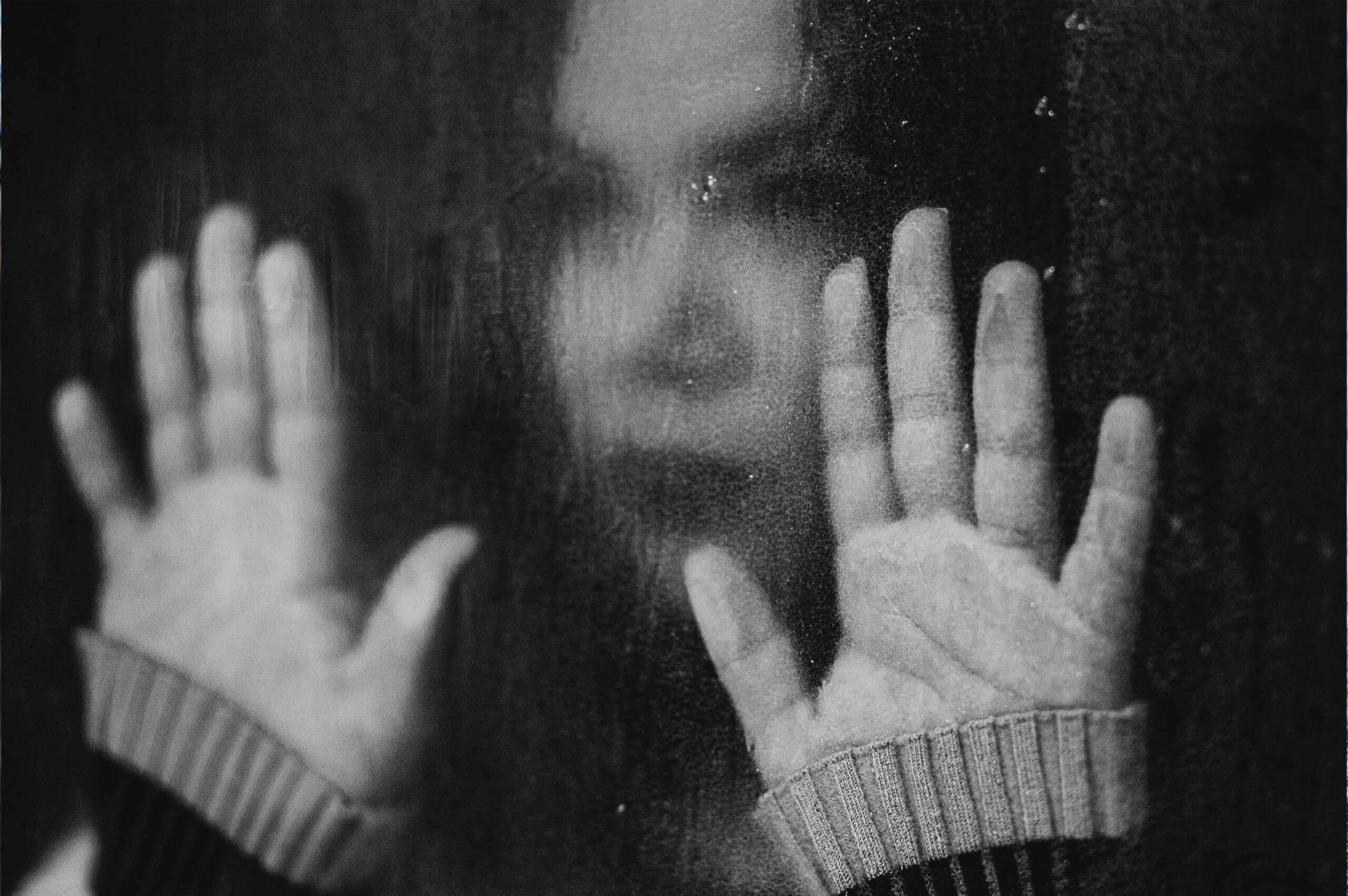 a woman looking out a foggy window